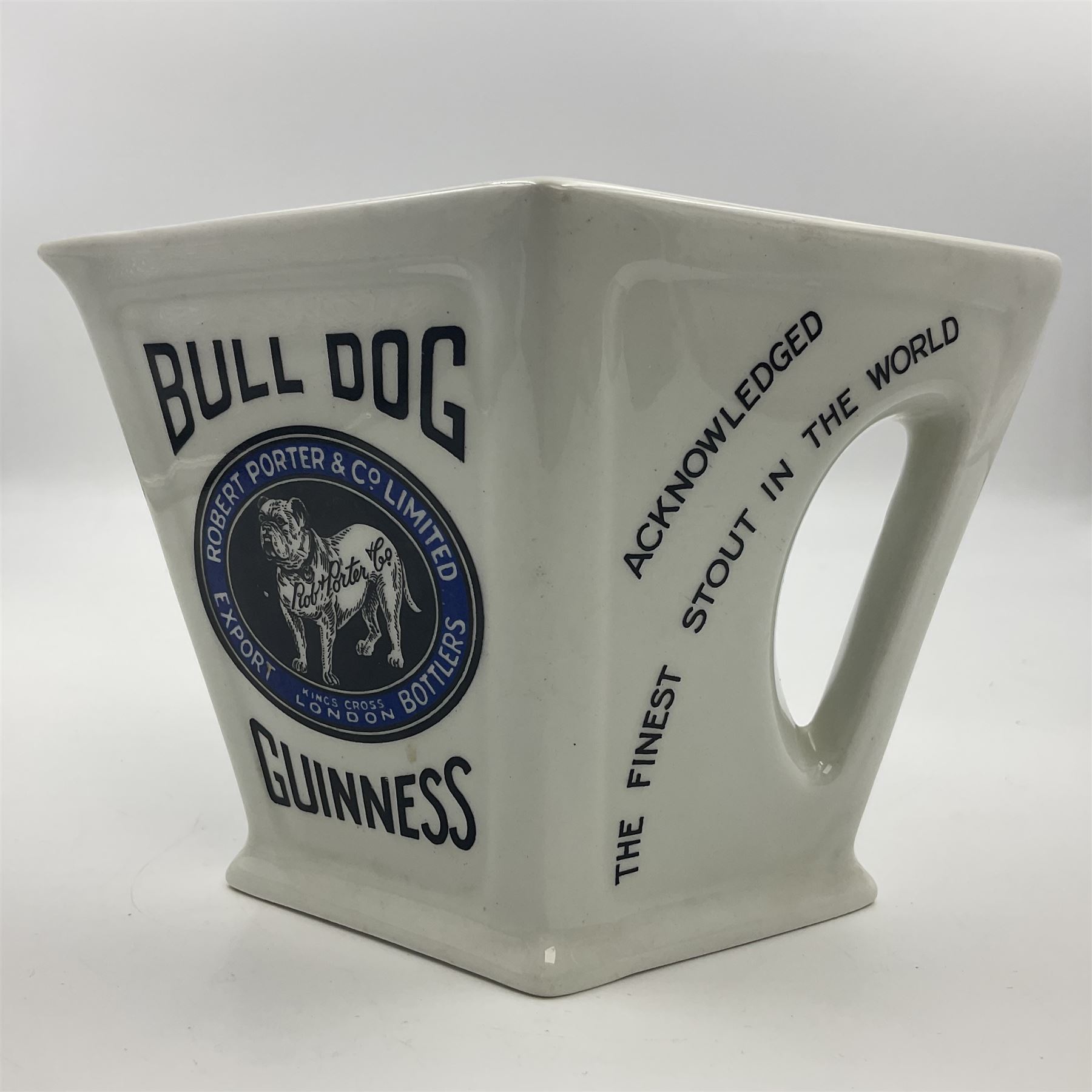 Royal Doulton Guinness advertising whiskey water jug, circa 1930s by Robert Porter and Co. of lozenge angled form, decorated with the  bulldog Guinness, H11cm