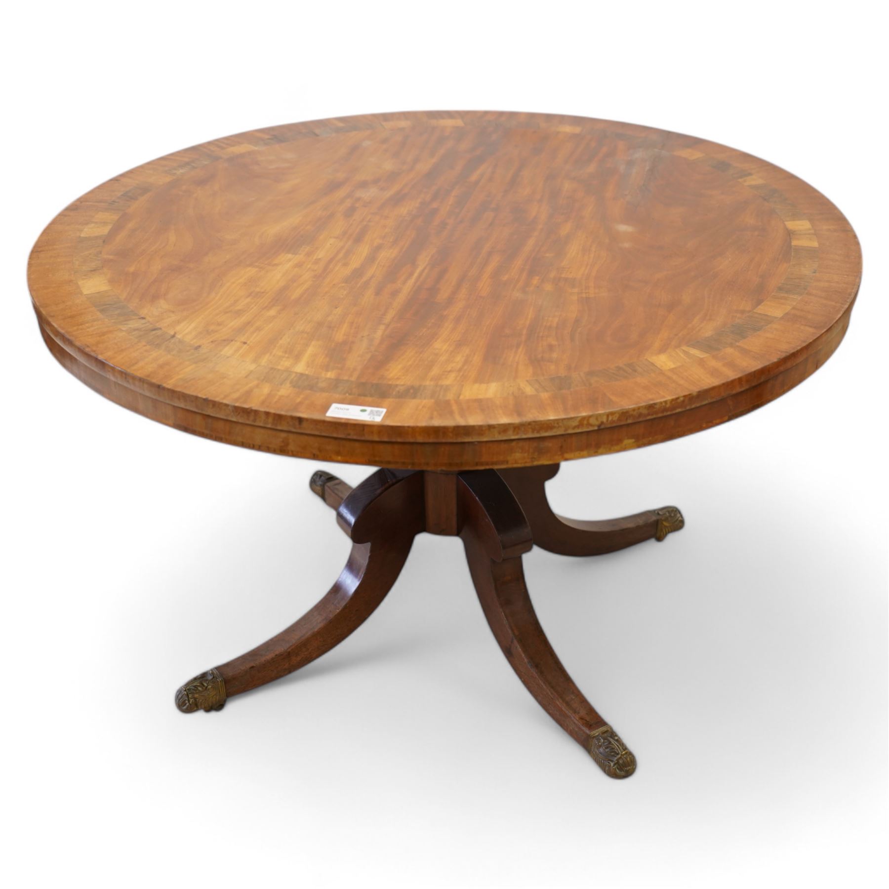 George III mahogany and rosewood banded breakfast or centre table, circular tilt-top with figured veneers and rosewood band, on turned column with four out-splayed supports, ornate cast brass castors 