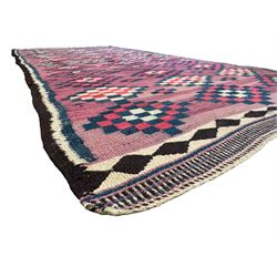 Turkish Anatolian lilac ground kilim rug, the field decorated with three columns of geometric lozenges, enclosed by plain guard stripes 