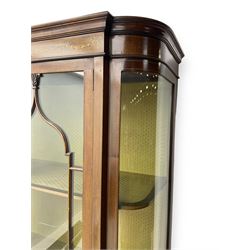 Edwardian inlaid mahogany display cabinet, projecting moulded cornice over two glazed doors, flanked by curved glazed sides and central arched panel with floral medallion, raised on square tapering supports with spade feet united by undertier