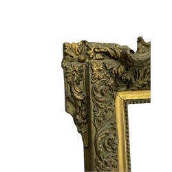 Victorian giltwood and gesso wall mirror, pierced shell cartouche pediment decorated with C-scrolls and curled leaves, moulded frame with curled acanthus leaf decoration and beaded inner slip, the corner brackets decorated with flower heads 