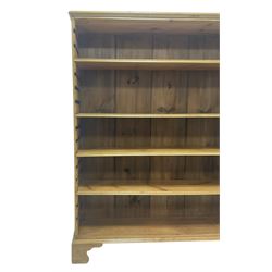 Georgian and later pine open bookcase, fitted with three adjustable shelves, on bracket feet