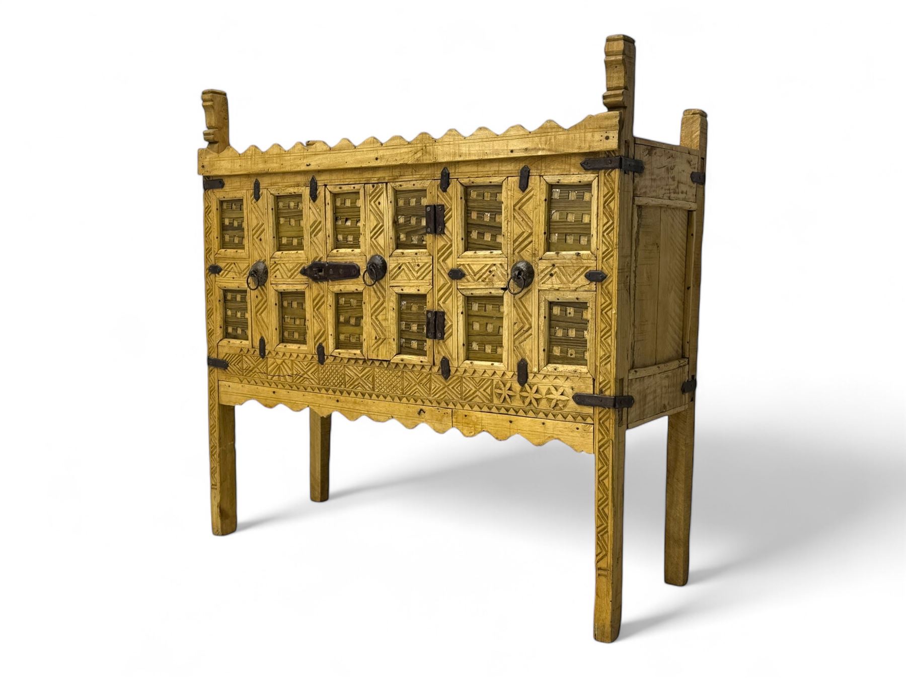 Late 19th century Indian teak damchiya chest, panelled front enclosed by single door, with metal bands and handles 