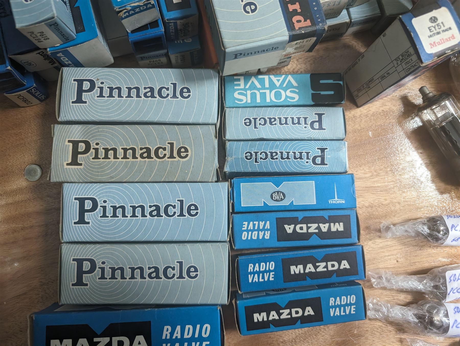 Large collection of thermionic valves/vacuum tubes, by various makers, mostly wrapped in bubble wrap with identifying stickers, together with a collection of empty valve boxes including Pinnacle, Mullard etc