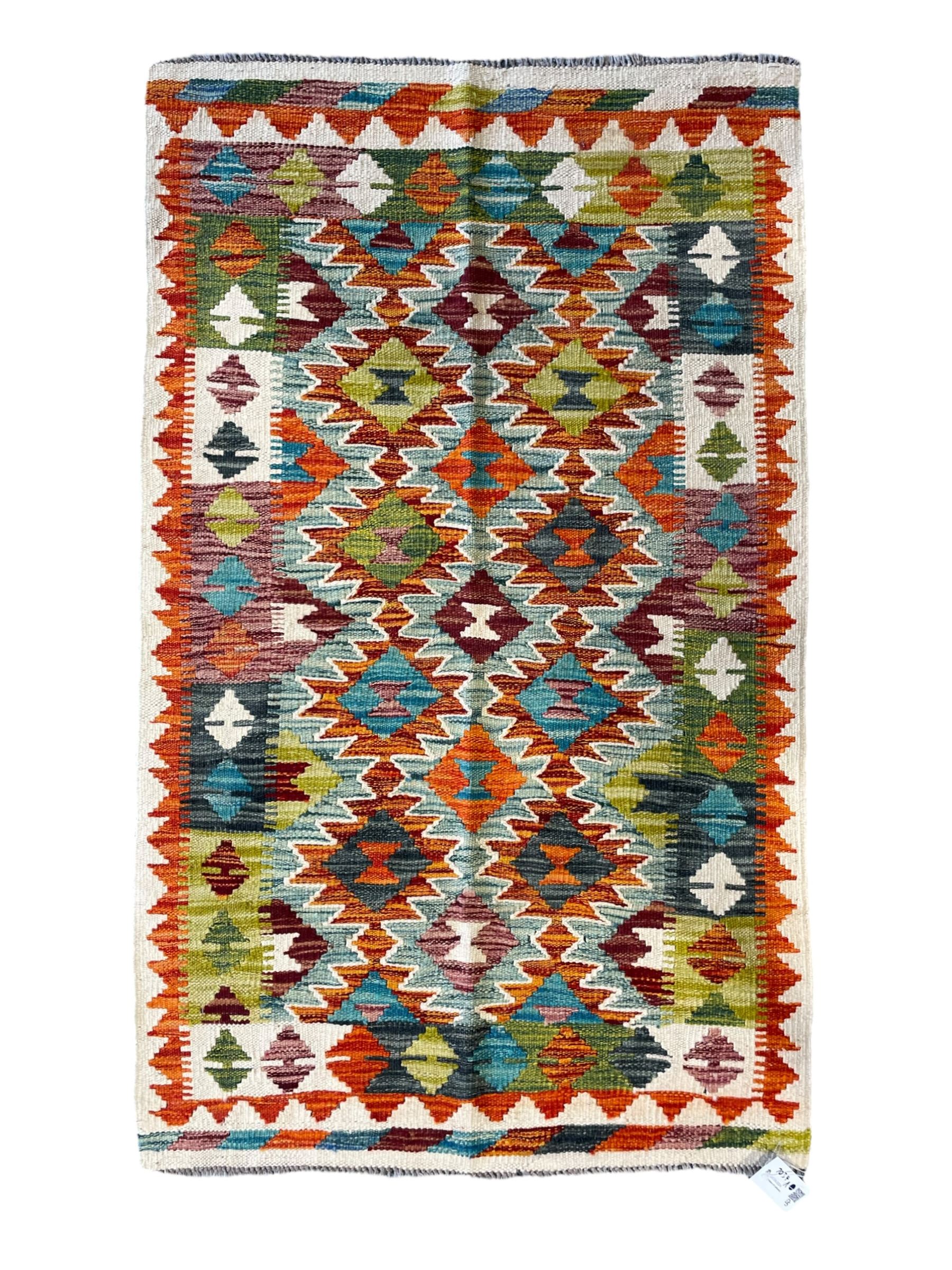 Chobi Kilim ivory ground rug, the busy multi-coloured field decorated with two concentric lozenges, the guard lines decorated with broken-lozenge motifs and geometric designs