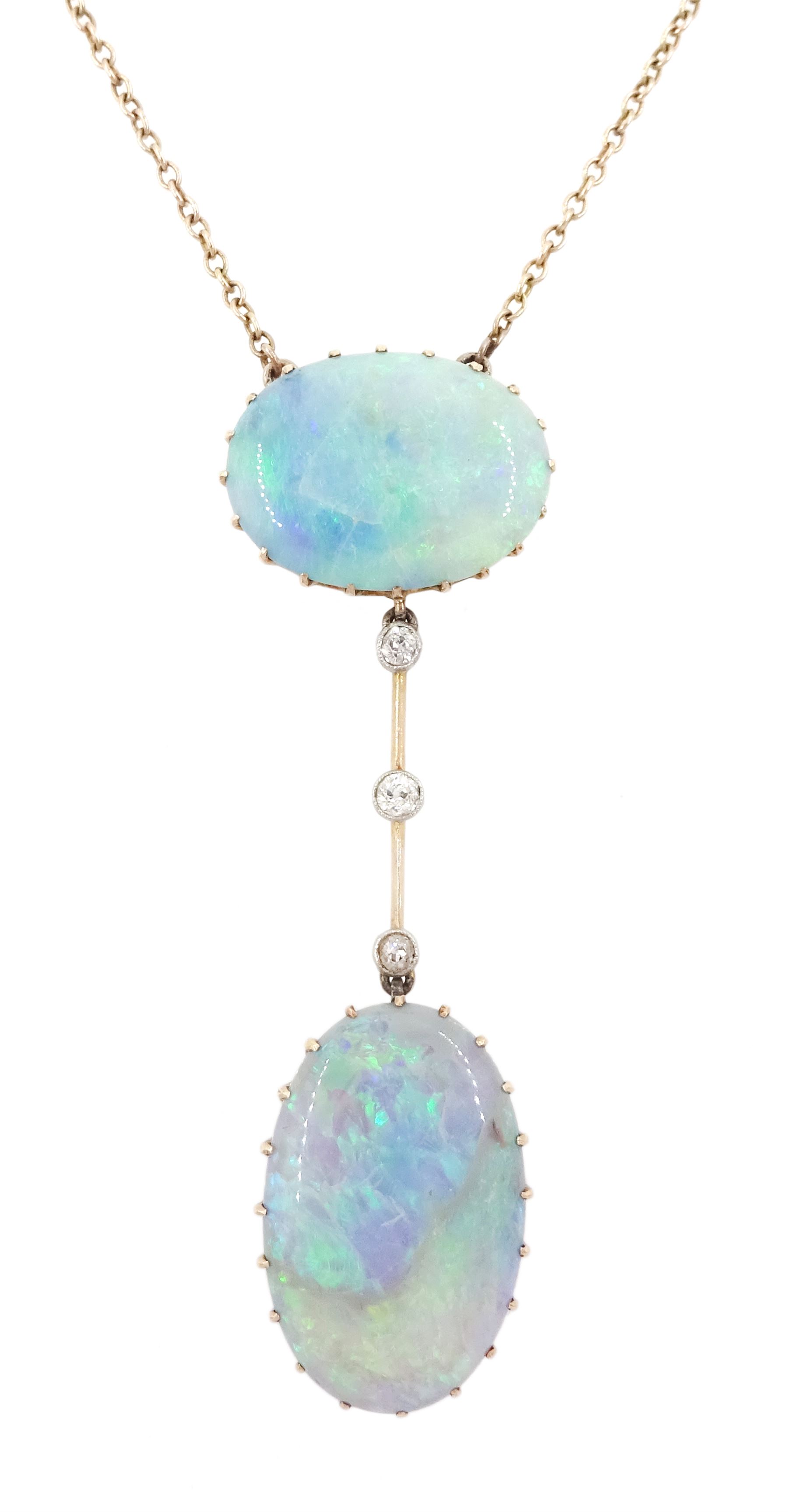 Early 20th century gold opal and diamond pendant necklace, two oval cabochon cut opals spaced by three milgrain set old cut diamonds, total opal weight approx 16.85 carat