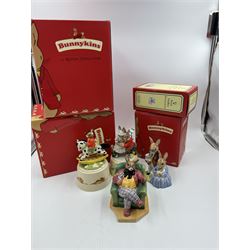 Two Royal Doulton Bunnykins music boxes, comprising Rocking Horse and Winter Waltz together with two Royal Doulton Bunnykins figures Once Upon a Time and Father, Mother & Victoria, all with original boxes  