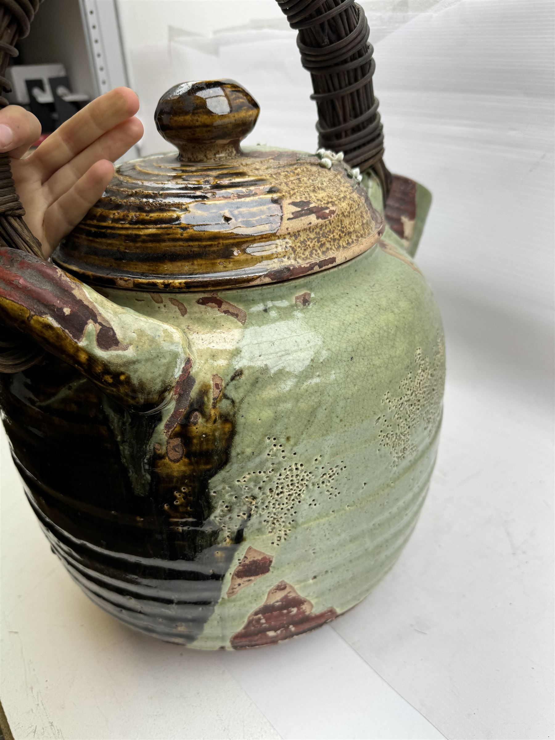 Very large Japanese Shigakari type coil built teapot, the body with a blossoming encrusted tree, woven loop handle and part green glazed spout and cover, H52cm