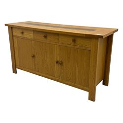 Contemporary oak sideboard, rectangular top with central contrasting plank, over three frieze drawers and three cupboards with enclosed shelving, on rectangular stile supports