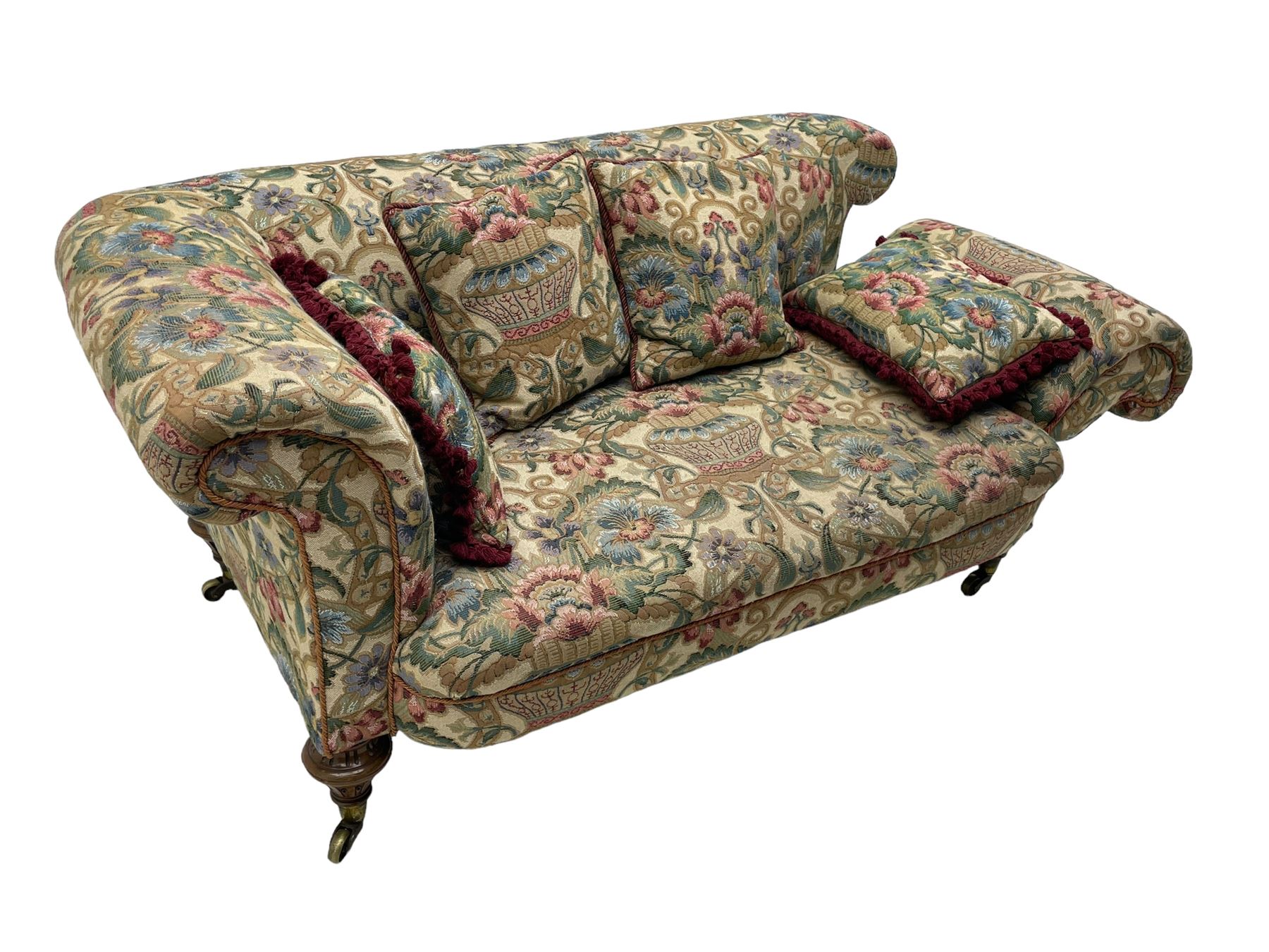 Mid-19th century walnut framed two-seat sofa, rolled arms over sprung seat, single drop-end action, raised on turned and fluted feet with brass cups and castors, upholstered by E & S Gott in traditional floral pattern fabric decorated with urns