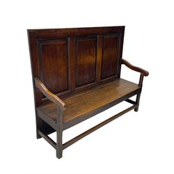 18th century oak settle, the high back with three fielded panels, shaped arms and solid plank seat, standing on square supports joined by stretchers