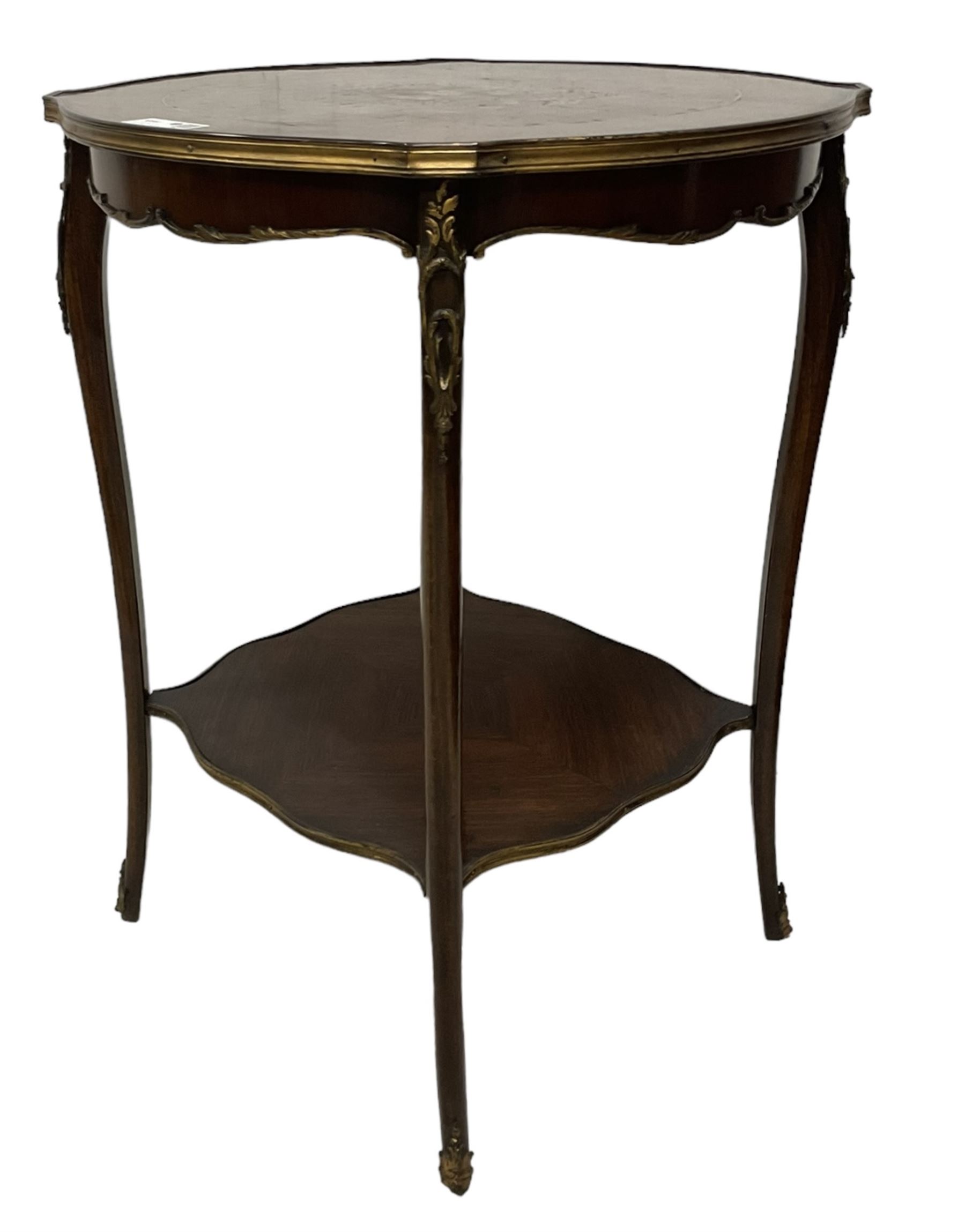 Early 20th century French two-tier marquetry inlaid walnut side table, shaped circular top with gilt metal edge, central chequered inlaid circular panel with floral motif, raised on cabriole supports with gilt metal mounts, united  by undertier