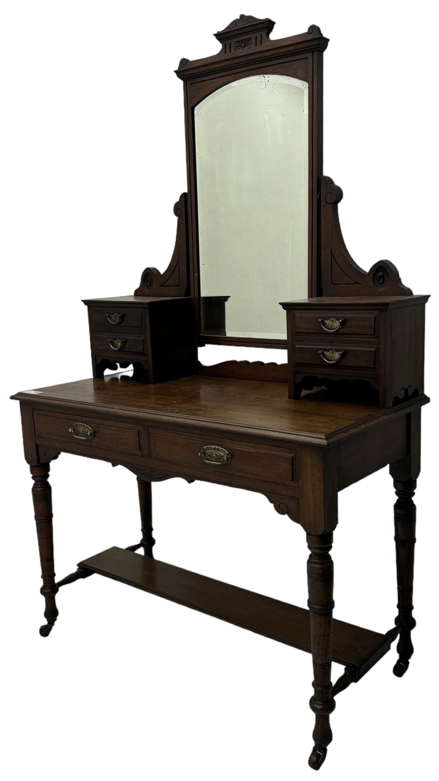 Late Victorian walnut dressing table, raised bevelled swing mirror over small trinket drawers, rectangular moulded top, fitted with two drawers, on turned supports united by undertier 