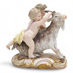 Meissen porcelain group modelled as two cherubs playing with a goat, the oval scroll moulded base heightened in gilt, blue crossed swords, inscribed no. 2454, H10cm, together with a Meissen figure of a young girl and boy, possibly emblematic of autumn, unmarked, (2) Provenance: From the Estate of the late Dowager Lady St Oswald