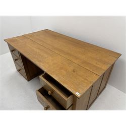 'Gnomeman' oak twin pedestal desk, rectangular adzed top, each pedestal fitted with three graduating drawers, panelled back and sides, carved with gnome signature