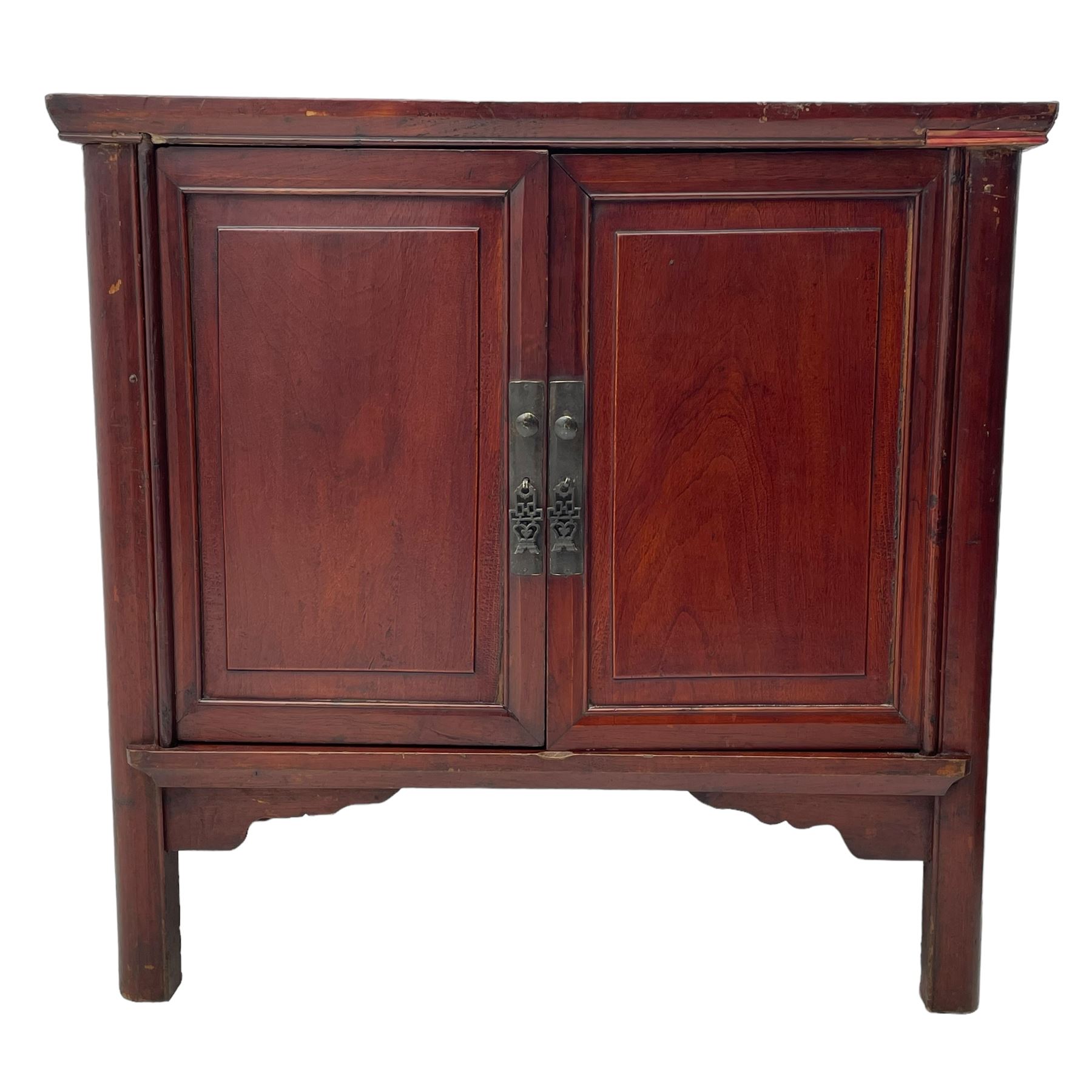 Pair of early 20th century Chinese red lacquered elm storage cupboards, rectangular top over two panelled doors, fitted with two internal drawers, on square supports with curved outer edge, panelled sides