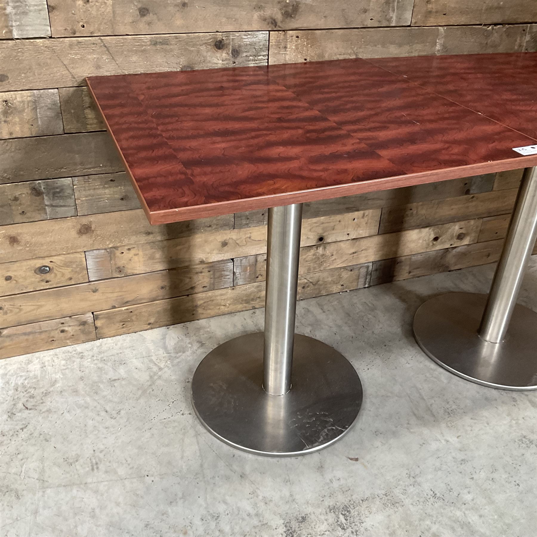 Two rosewood square restaurant tables, metal pedestal base