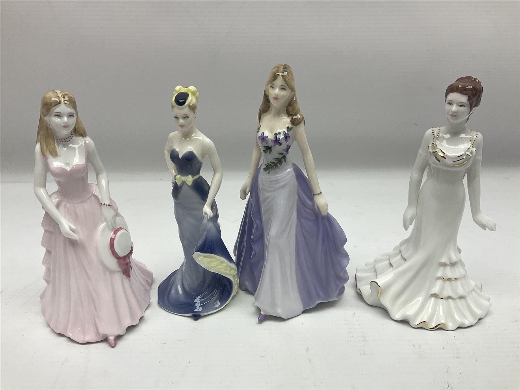 Three Royal Doulton figures, comprising Anna HN4391, Kirsty HN2381 and Deborah HN4468, together with a similar Coalport figure and ten smaller Coalport figures (14)