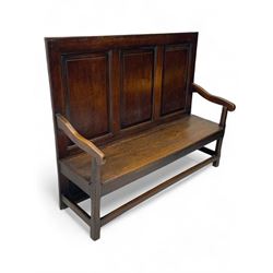 18th century oak settle, the high back with three fielded panels, shaped arms and solid plank seat, standing on square supports joined by stretchers