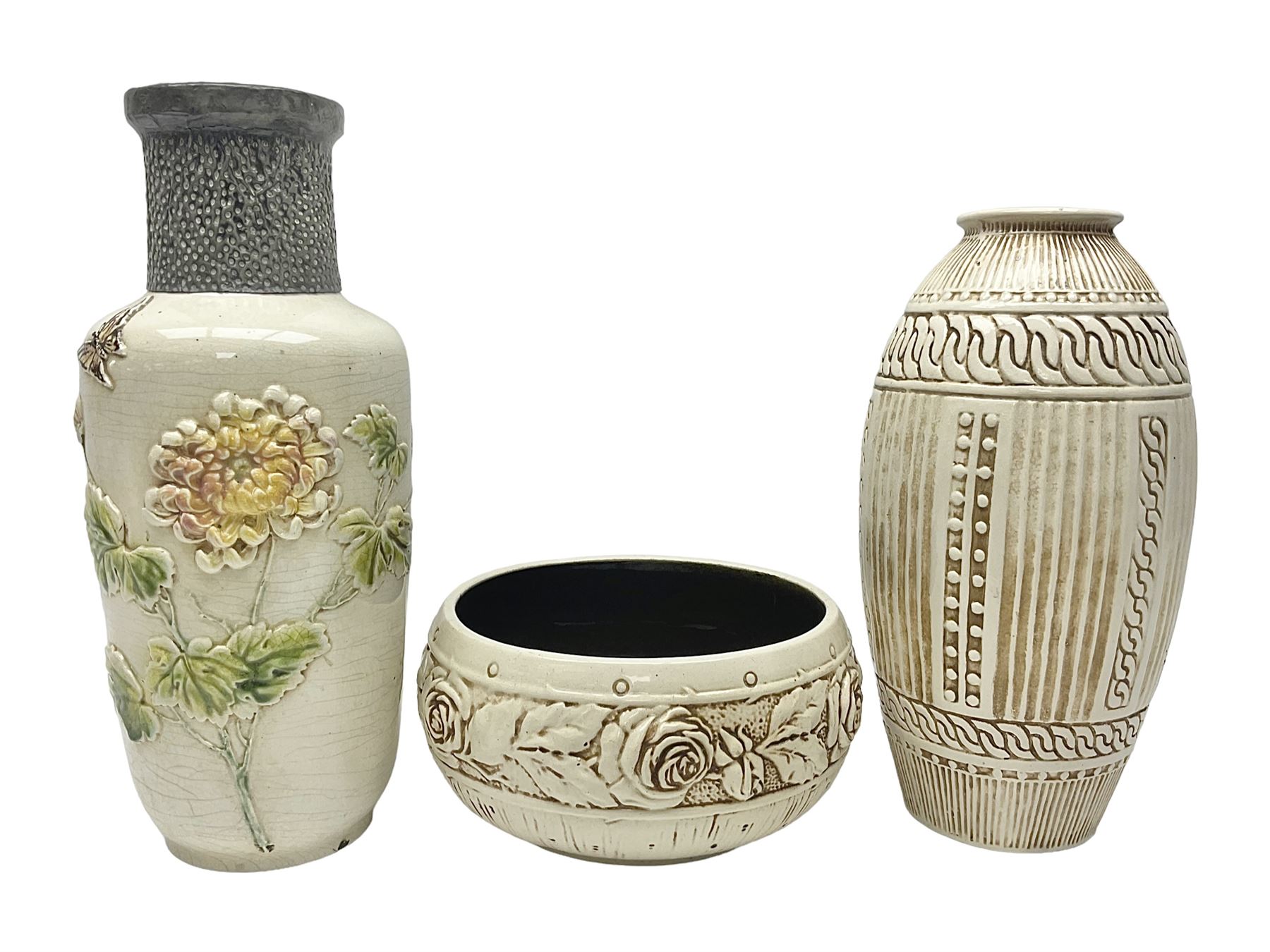 Bretby vase, of baluster form, with fluted and chain link decoration upon an ivory ground, together with a similar Bretby bowl, decorated with a band of roses upon an ivory ground, both with impressed marks beneath, and one other vase, with relief floral decoration and pewter cased rim, tallest H33cm