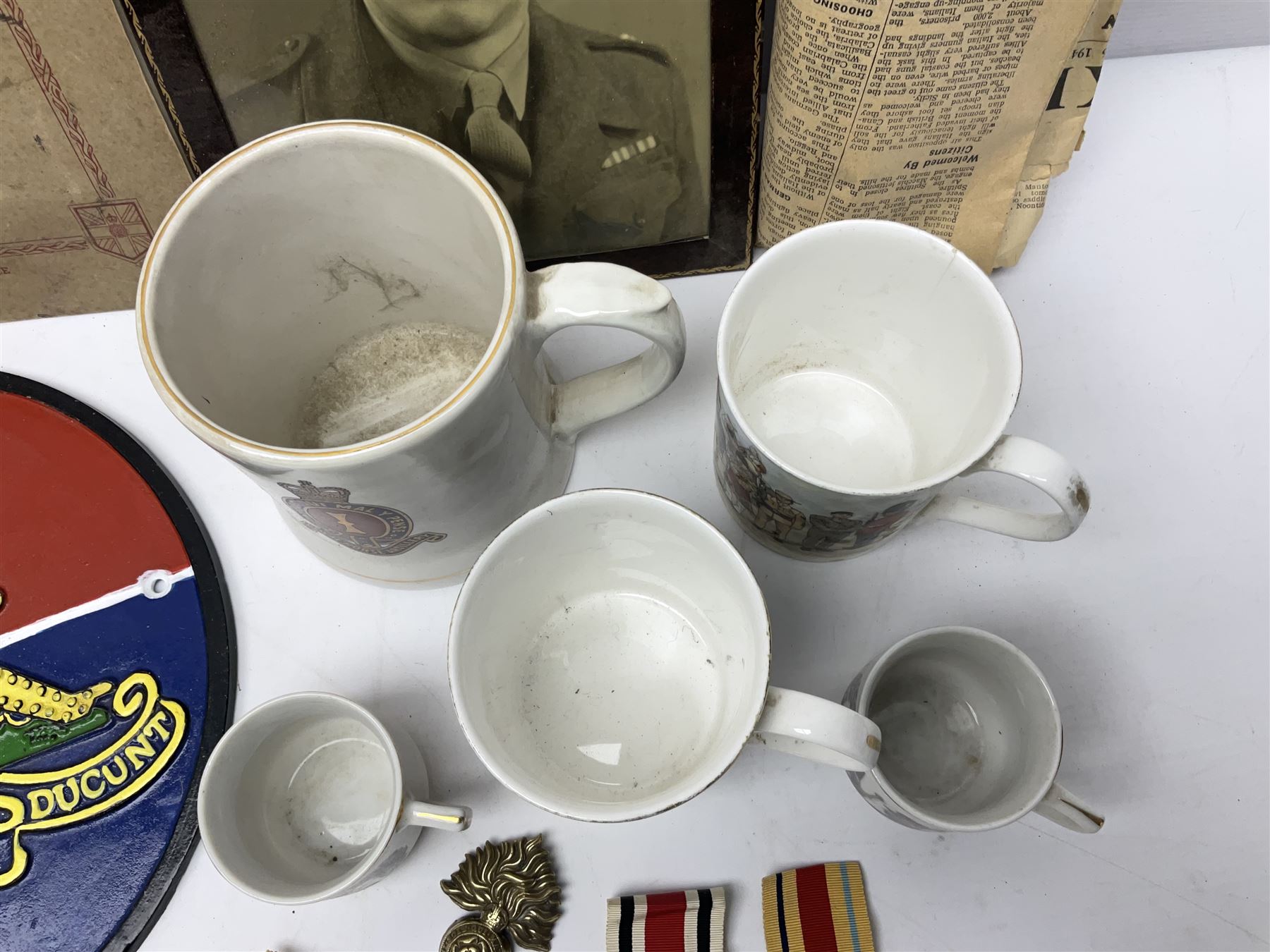 Collection on military items, including John Player & Sons Military Uniforms of the British Overseas, medal ribbon, ceramics and a reproduction metal plaque 