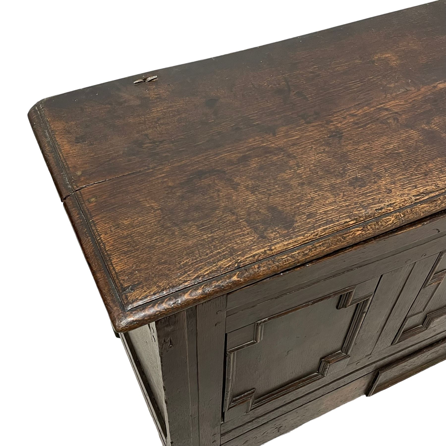 18th century oak mule chest, rectangular hinged top with moulded edge enclosing candle box, the triple panelled front with geometric fielded mouldings, fitted with single drawer to base, raised on stile feet