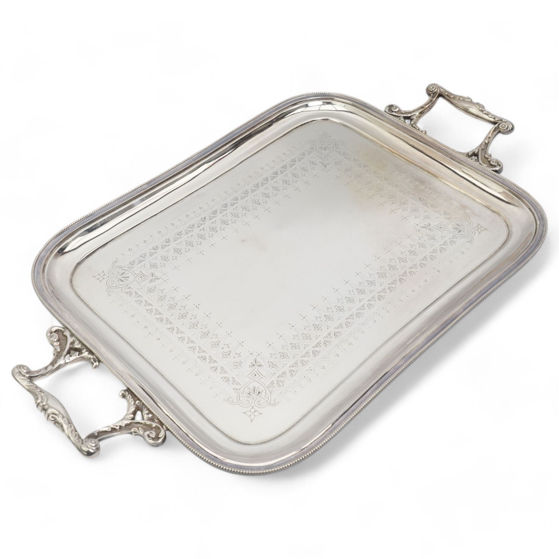 Walker & Hall two handled tea tray, 51cm over handles, two silver plated four division toast racks, and a silver fronted easel photograph frame, Birmingham 1907, H20cm