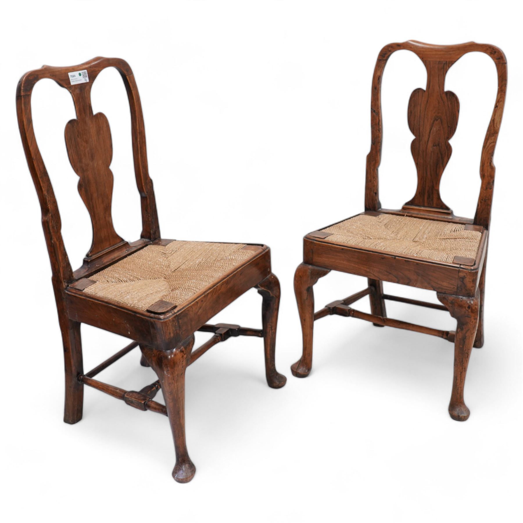 Pair of 18th century elm side chairs, shaped splat back over drop-in rush seat, on cabriole supports united by turned stretchers 