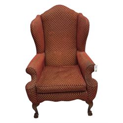 Early 20th century hardwood-framed wingback armchair, upholstered in red dotted fabric, on cabriole feet