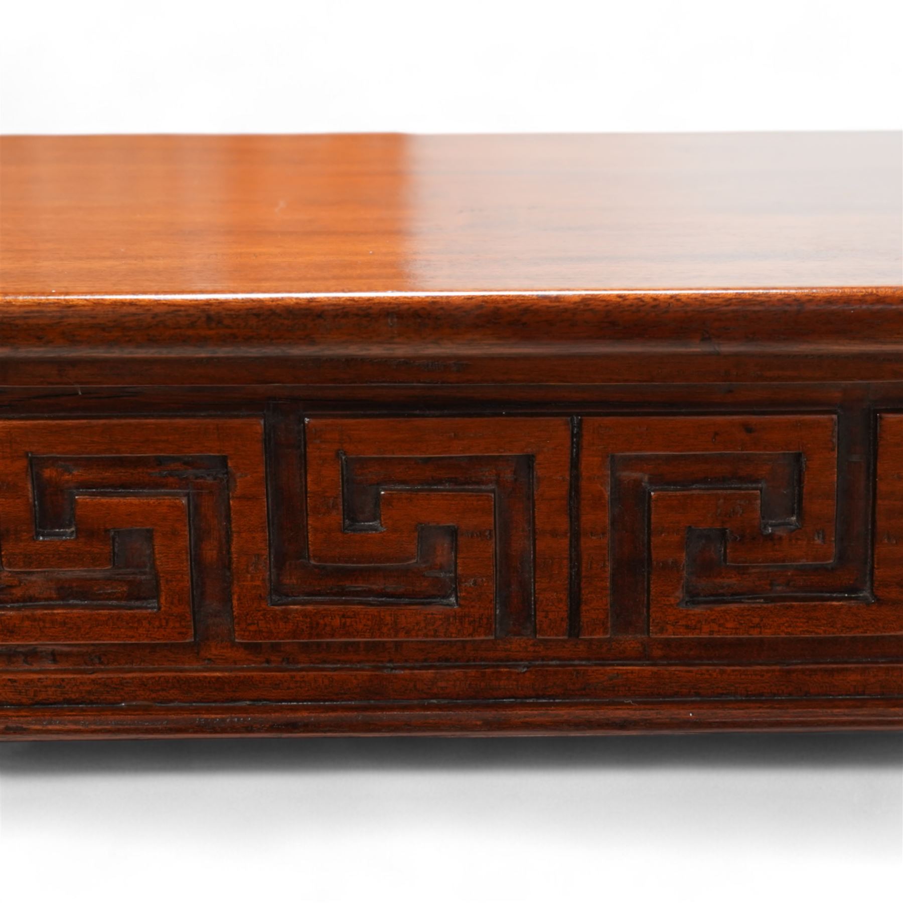 Neoclassical design mahogany console table, rectangular top over Greek key carved frieze with foliate carved back and sides, raised on twin pilaster end supports with acanthus capitals, on a plinth base