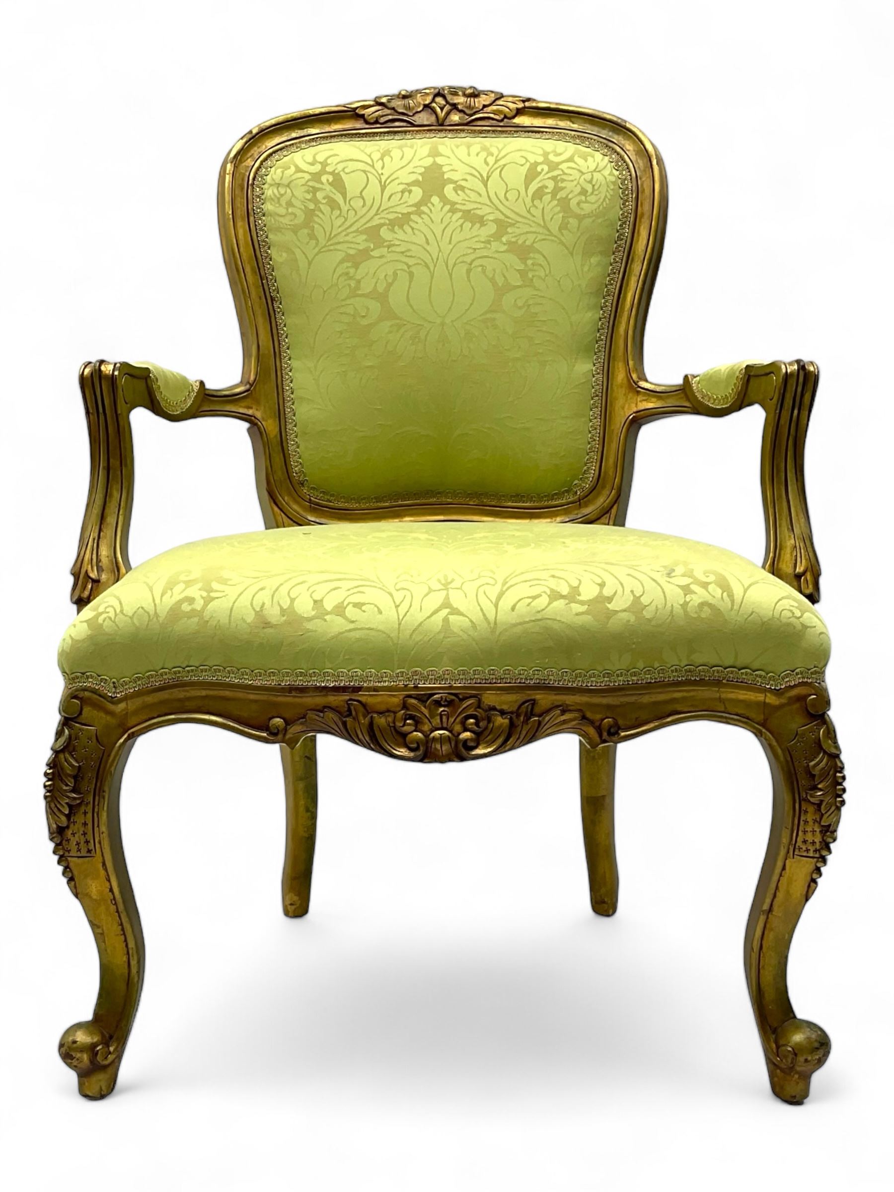 Late 20th century French design gilt framed armchair, upholstered in lime green damask fabric, arched back with carved crest, scroll arms, serpentine front rail, on cabriole front supports with ball feet