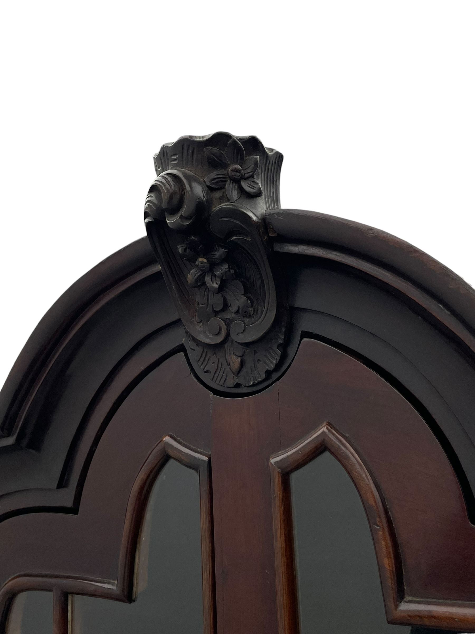 19th century Dutch mahogany vitrine on chest, shaped moulded pediment with central C-scroll and flowerhead carved mount, enclosed by two astragal glazed doors, the interior fitted with fabric lined shelves, four graduating long drawers below, on ball and claw carved feet 