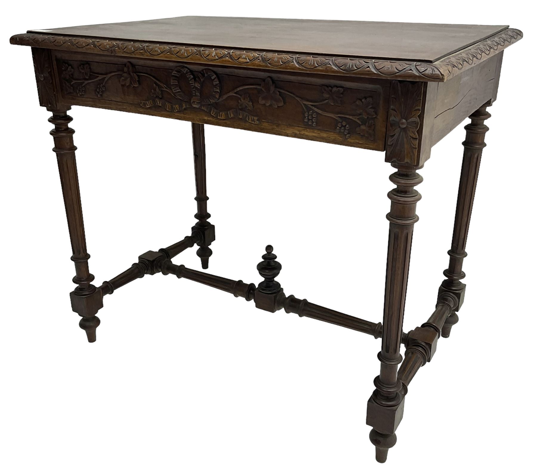 19th century walnut side table,  rectangular top with lunette carved moulded edge, the frieze drawer carved with ribbon and extending vine branch and grapes, on turned and fluted supports united by fluted stretcher with centre finial 