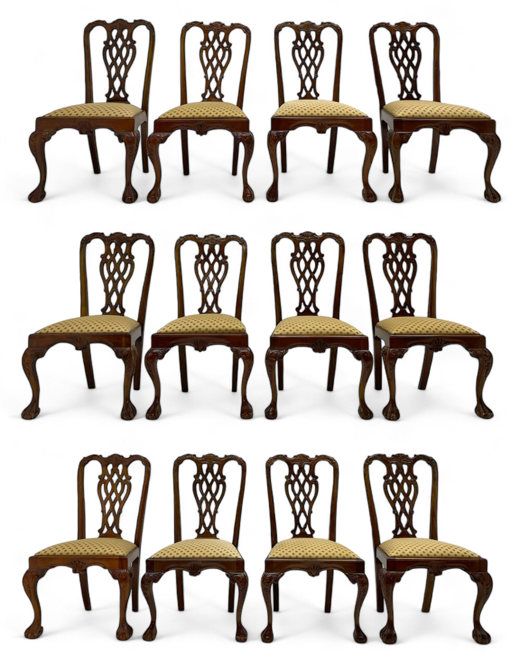 Set of twelve Chippendale design mahogany dining chairs, shaped cresting rail carved with foliage and C-scrolls, pierced interlaced splat with curled leaf decoration, upholstered drop-in seat, moulded seat rails, on scrolled acanthus carved cabriole supports with ball and claw feet 