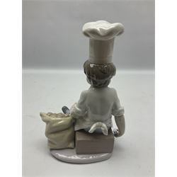 Lladro figure Chef's Apprentice, modelled as a young boy in Chef's whites with a sack of potatoes, sculpted by Antonio Ramos, no 6233, with original box, year issued 1995, year retired 1998, H20cm