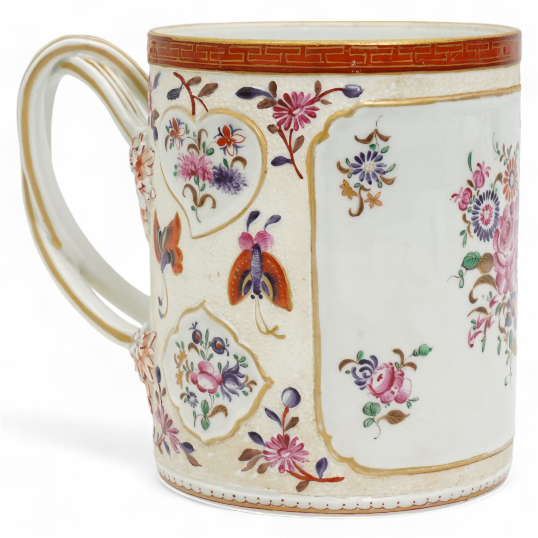 Large porcelain tankard by Samson of Paris, decorated in the Chinese Export famille rose style with panels of flowers, against a low relief ground of butterflies and floral sprigs, with reeded strapwork handle, H15cm