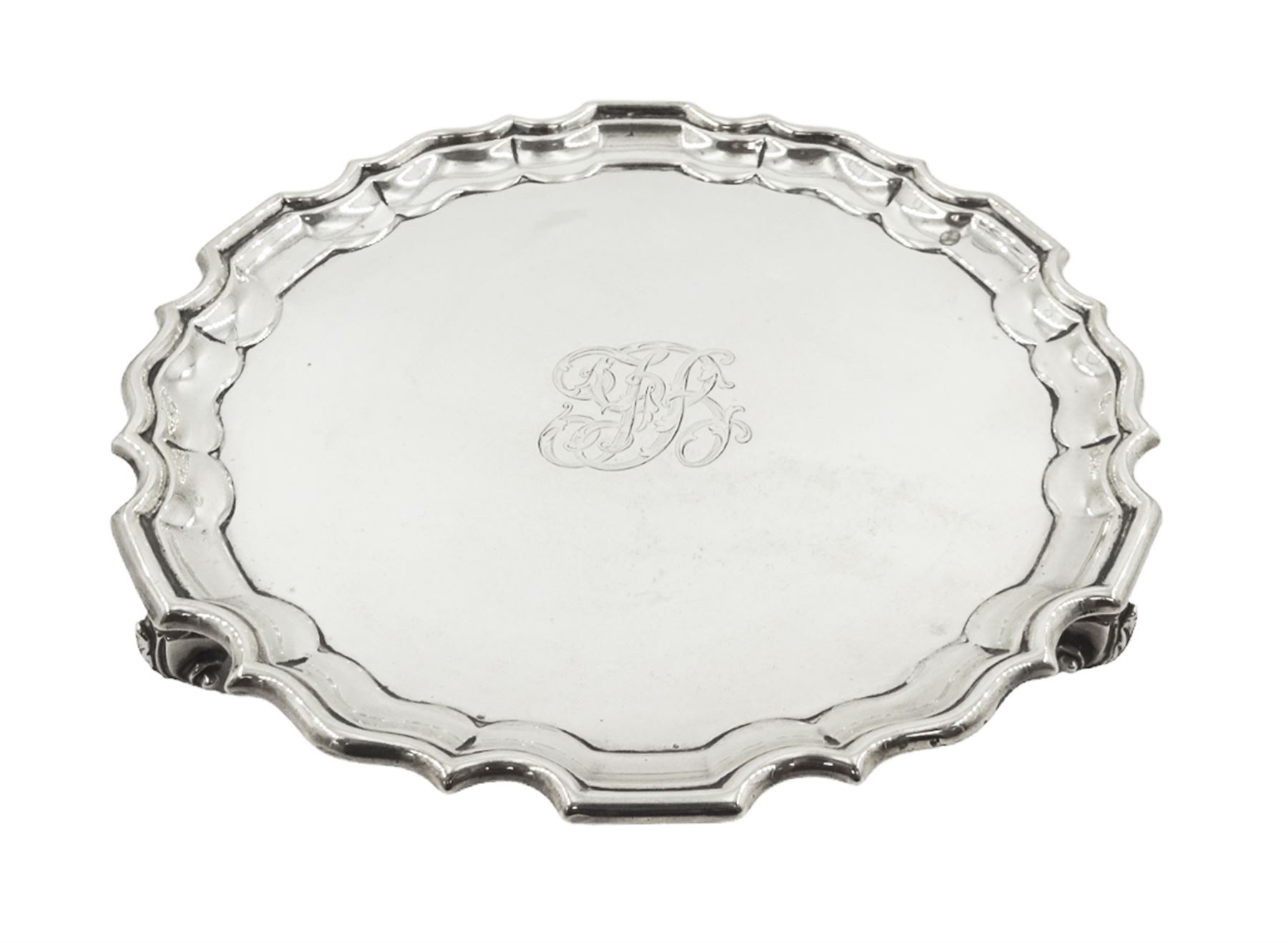 Early 20th century silver waiter, of circular form with pie crust rim, engraved with monogram to centre, upon three foliate feet, hallmarked Thomas Bradbury & Sons Ltd, London 1911, D15.5cm