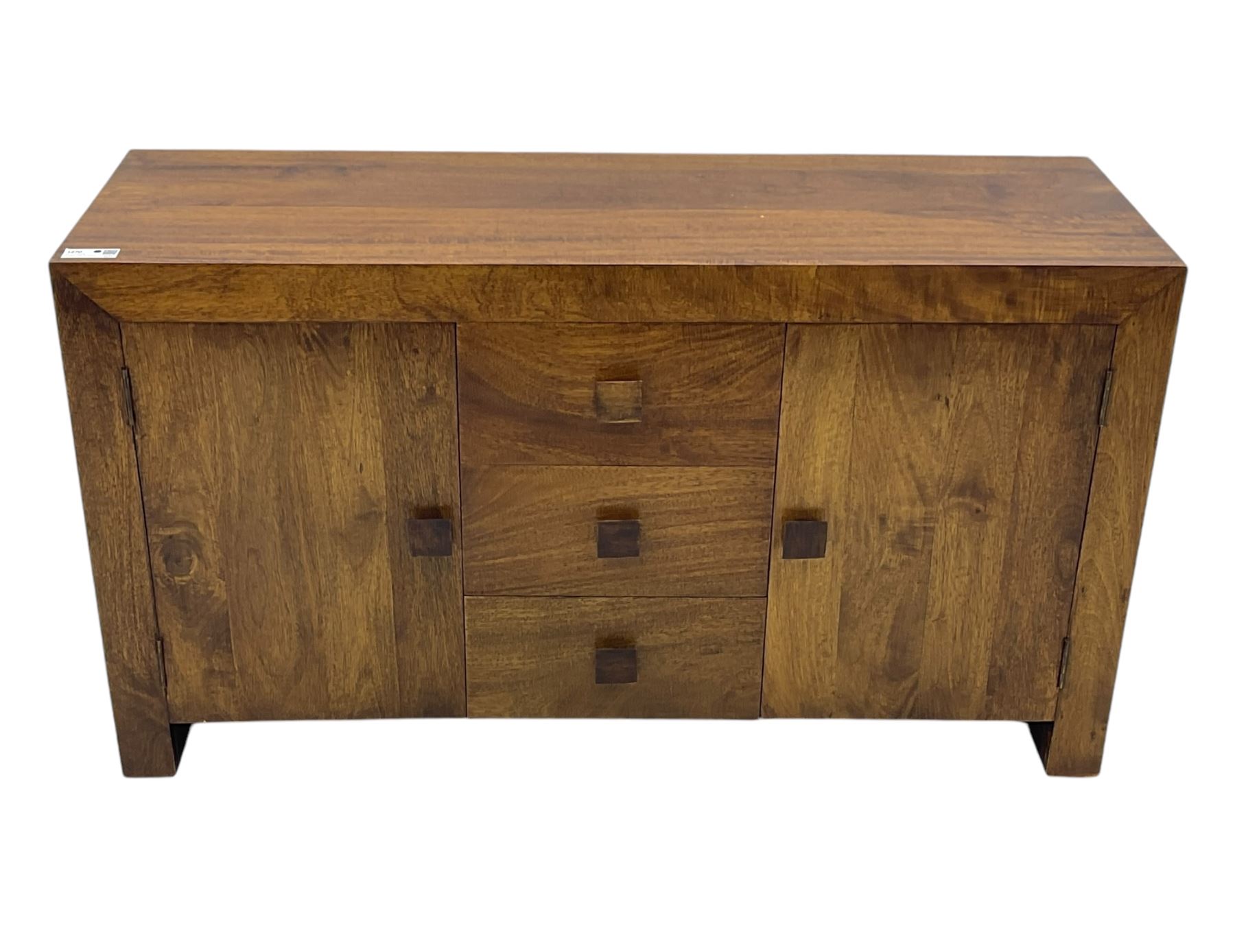 Contemporary Dakota mango wood sideboard, plain rectangular top over three central drawers flanked by cupboards with shelving, each with square pulls, raised on stile supports