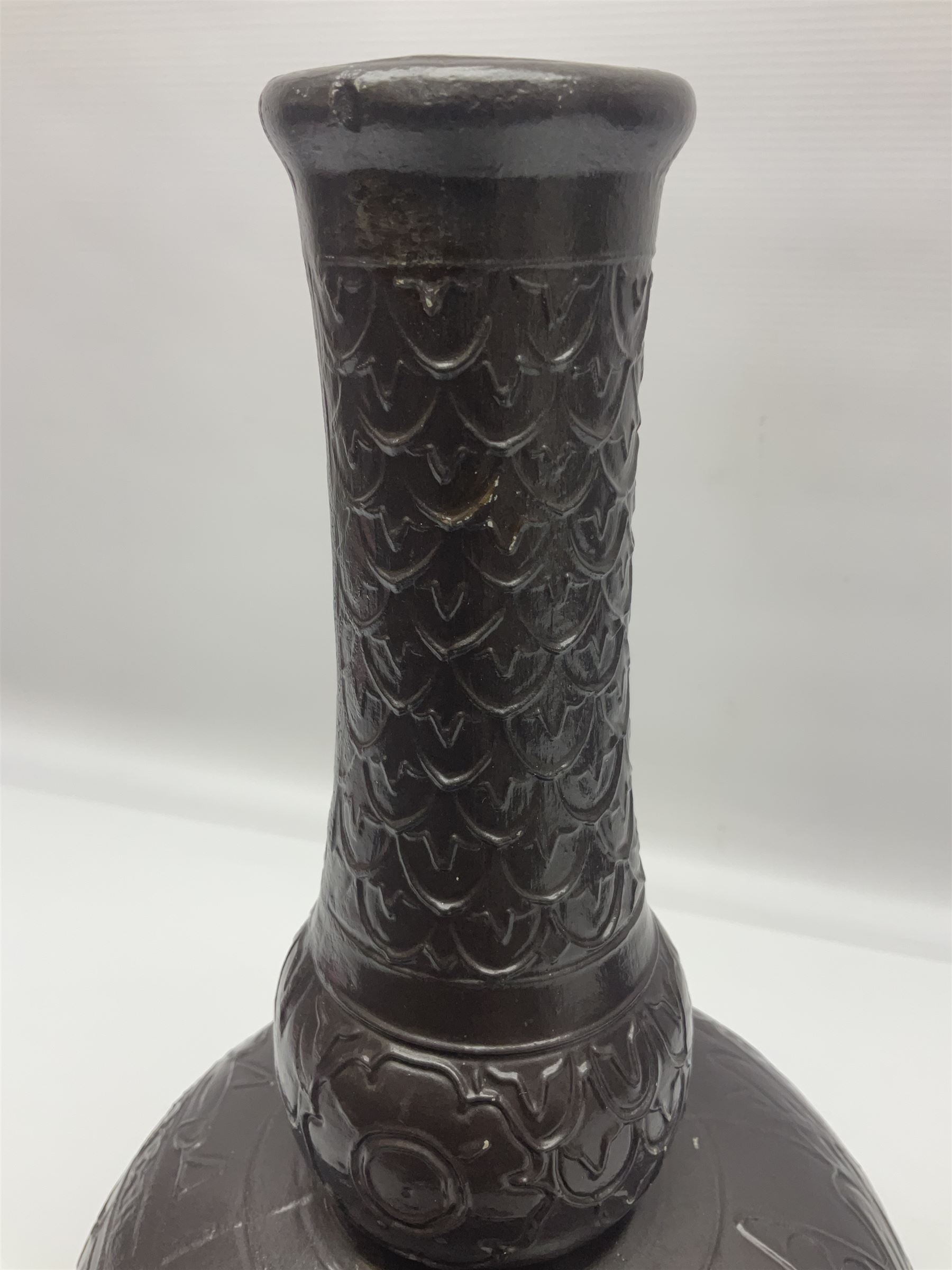 Burmantoft vase with slender neck, tubeline decoration on a brown ground, with impressed mark beneath, H38cm