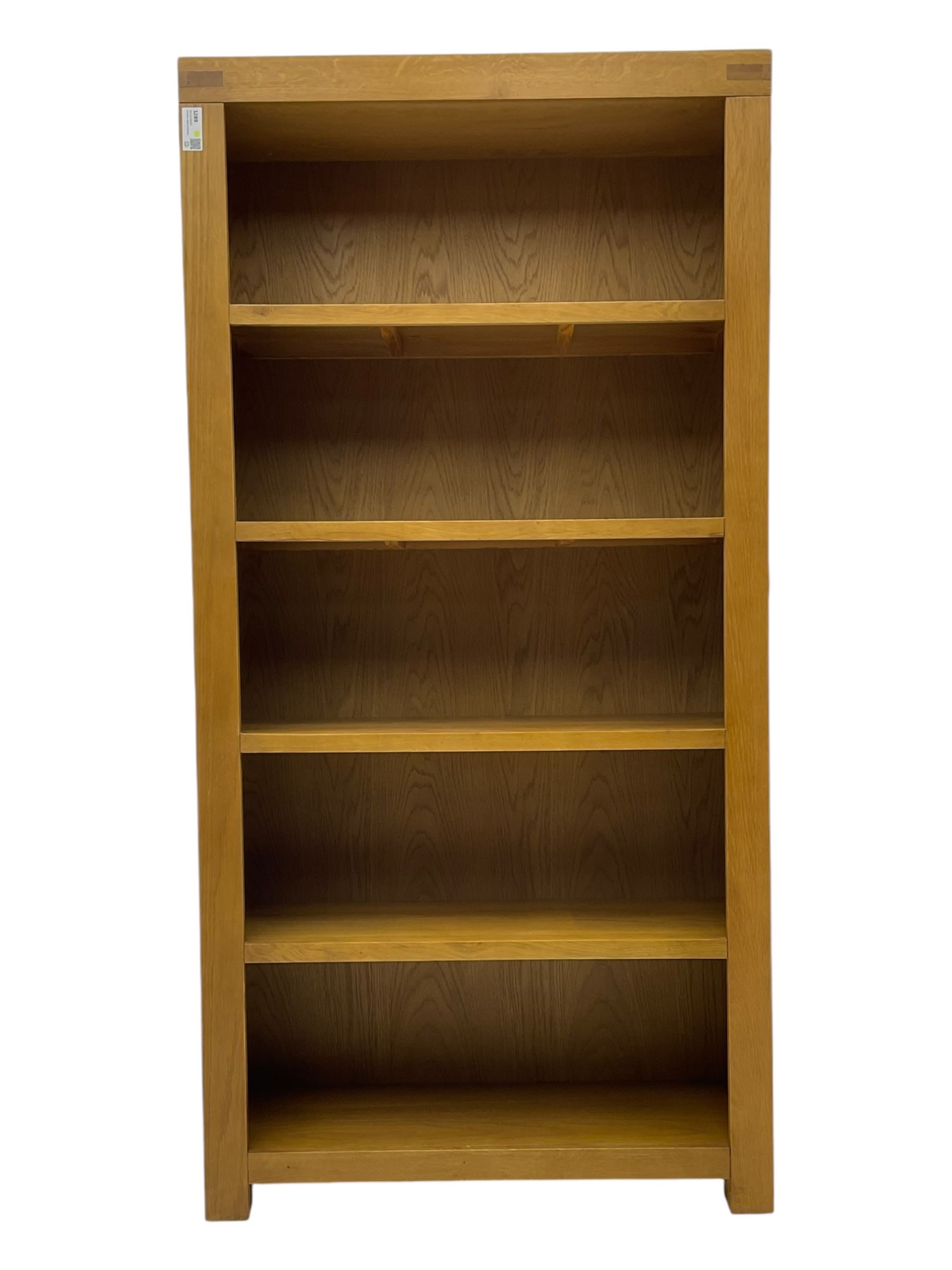 Light oak open bookcase fitted with four shelves 