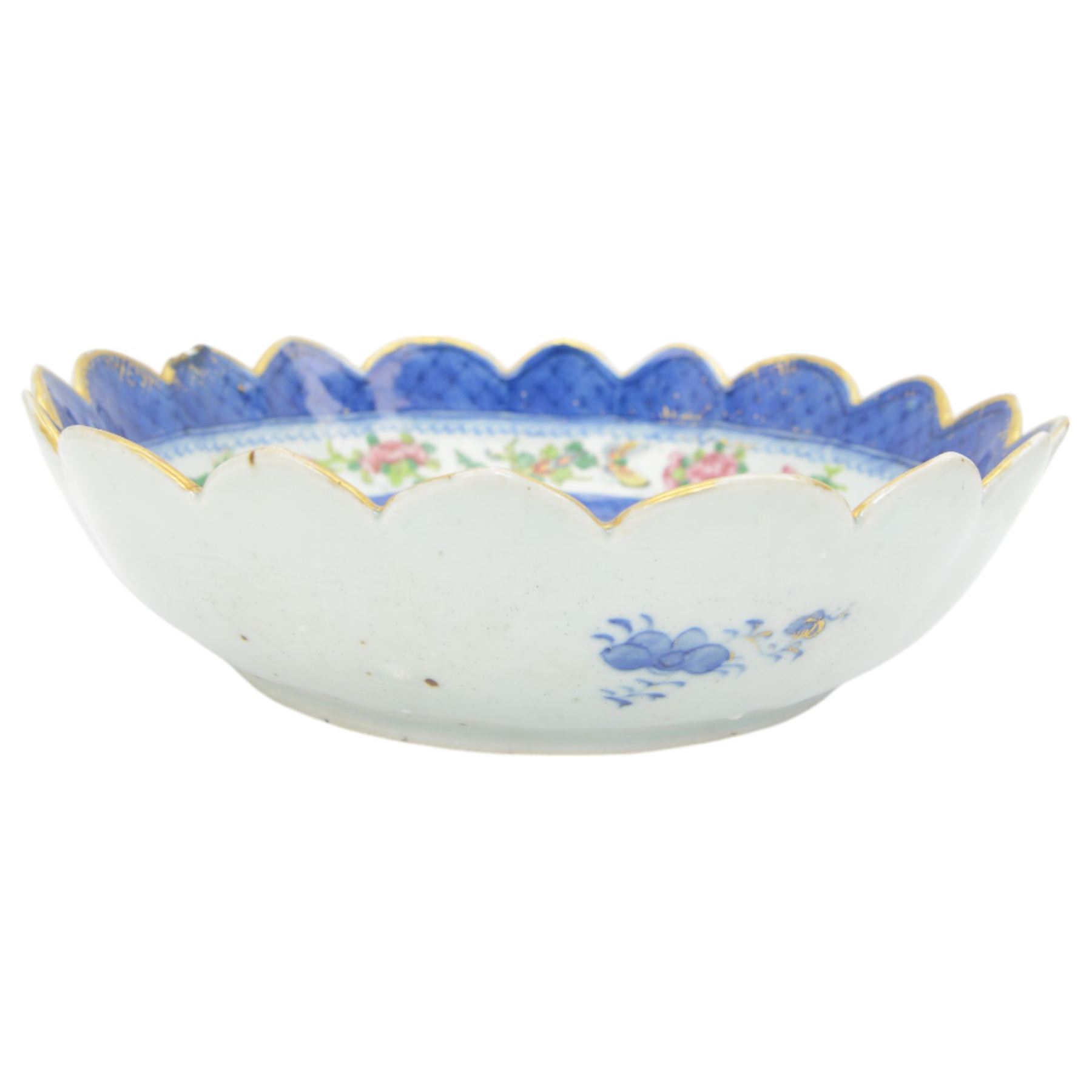 19th century/ early 20th century Chinese Canton blue and white bowl, centrally decorated with a landscape scene, within a famille rose enamelled border and scalloped rim, D26cm together with a Japanese Meiji Imari fluted bowl, decorated cranes, fans and scholar, D24cm (2)