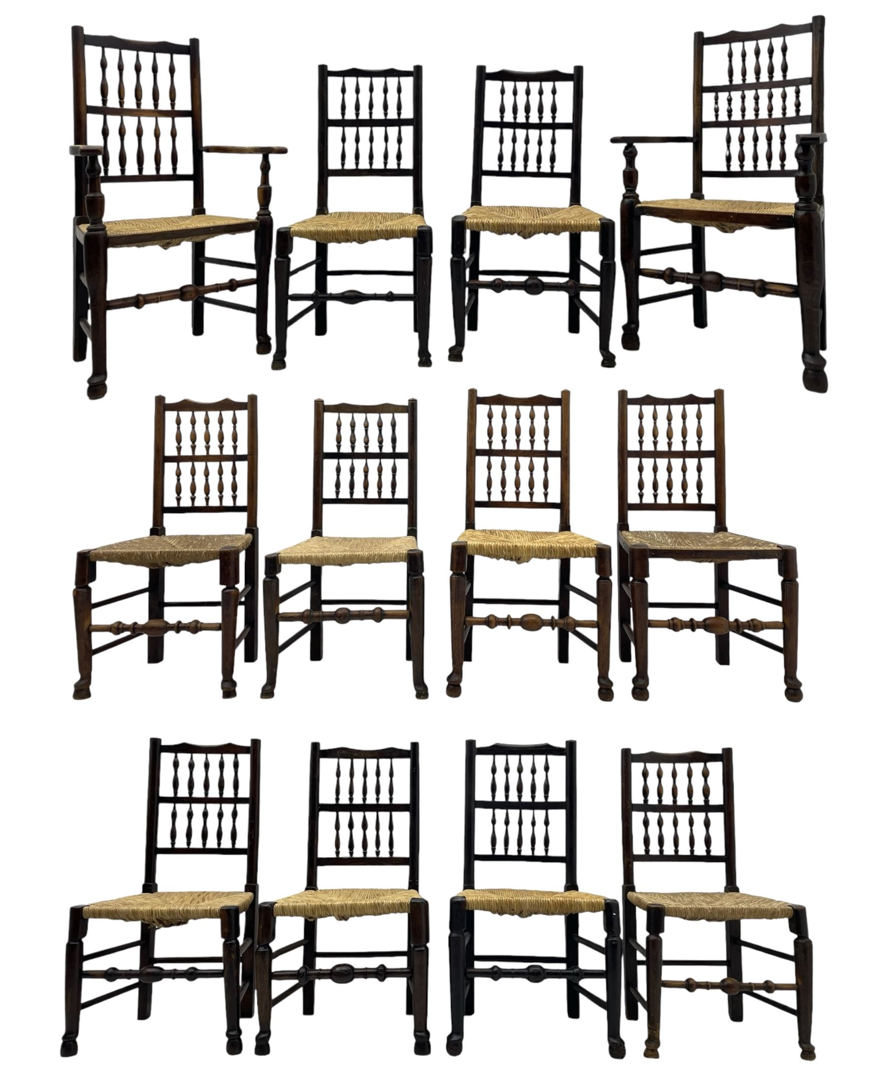 Matched set of twelve 19th century elm Lancashire spindleback dining chairs, shaped cresting rail over spindle back, rush seat, on turned supports united by turned stretchers, ring and globular turned front stretcher 