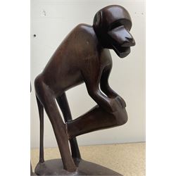 Two African carved hardwood figures, the first carved as a monkey, H43cm, the second as a male figure, H70cm