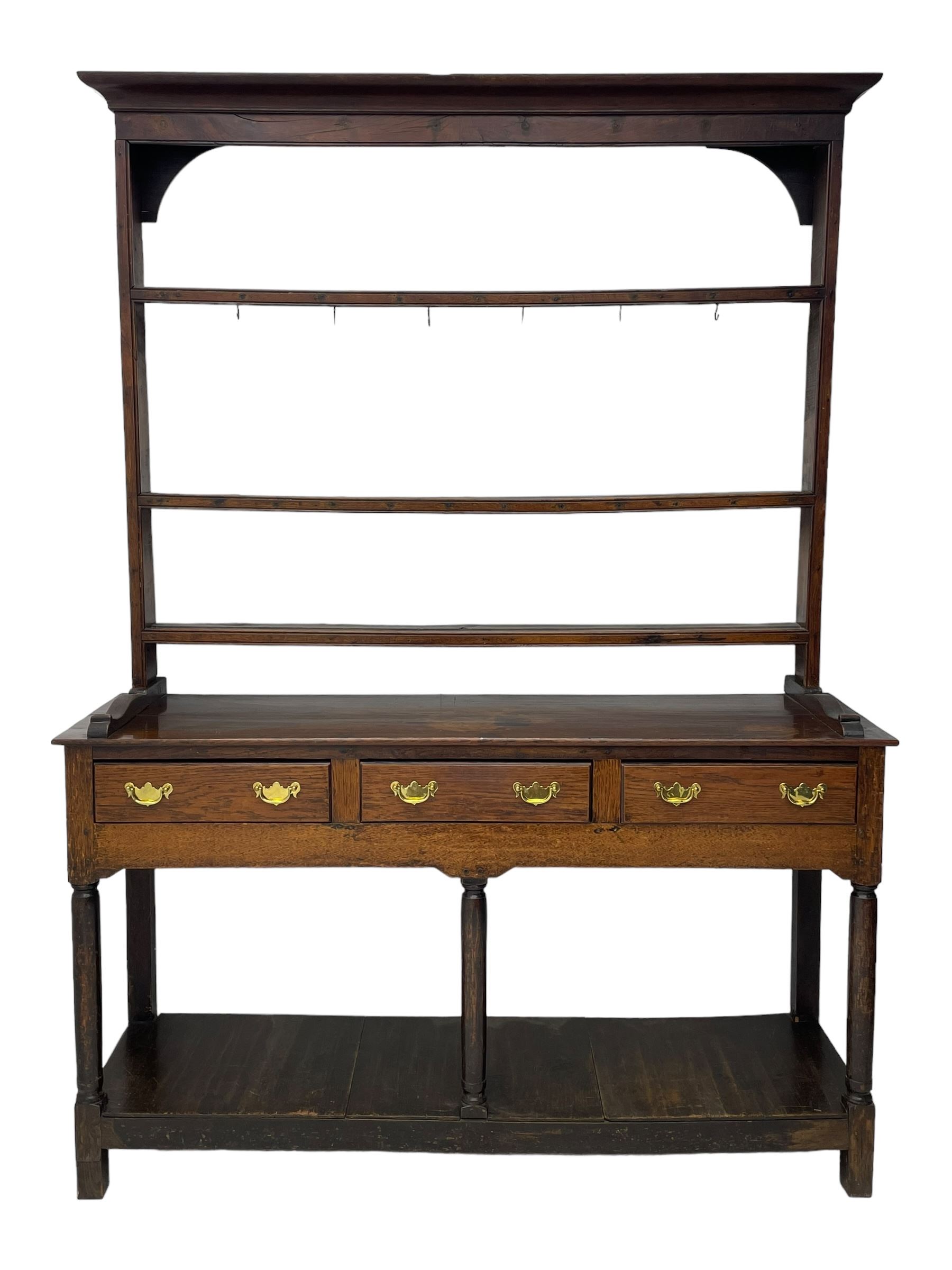 18th century oak dresser, raised three tier plate rack with moulded cresting rail, rectangular top over three drawers, the drawer fronts with moulded edges, turned supports united by pot board base 