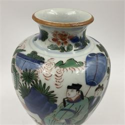 Chinese Wucai vase, of baluster form, decorated with an official and attendants in a garden setting, with crane, fence and rockwork, H19cm