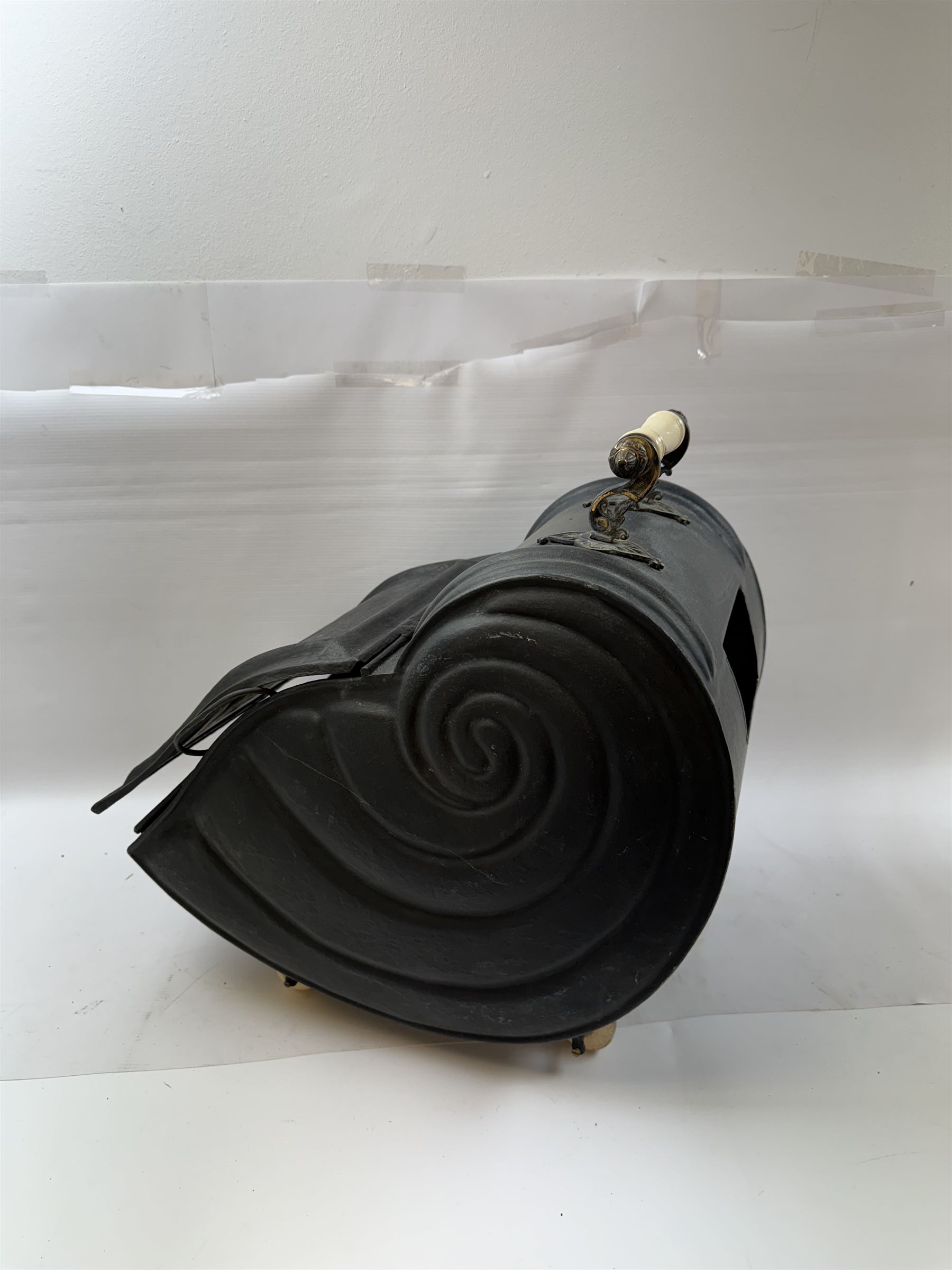 Victorian black matte metal coal scuttle, in the form of a nautilus shell, with ceramic wheels and handle, H47cm