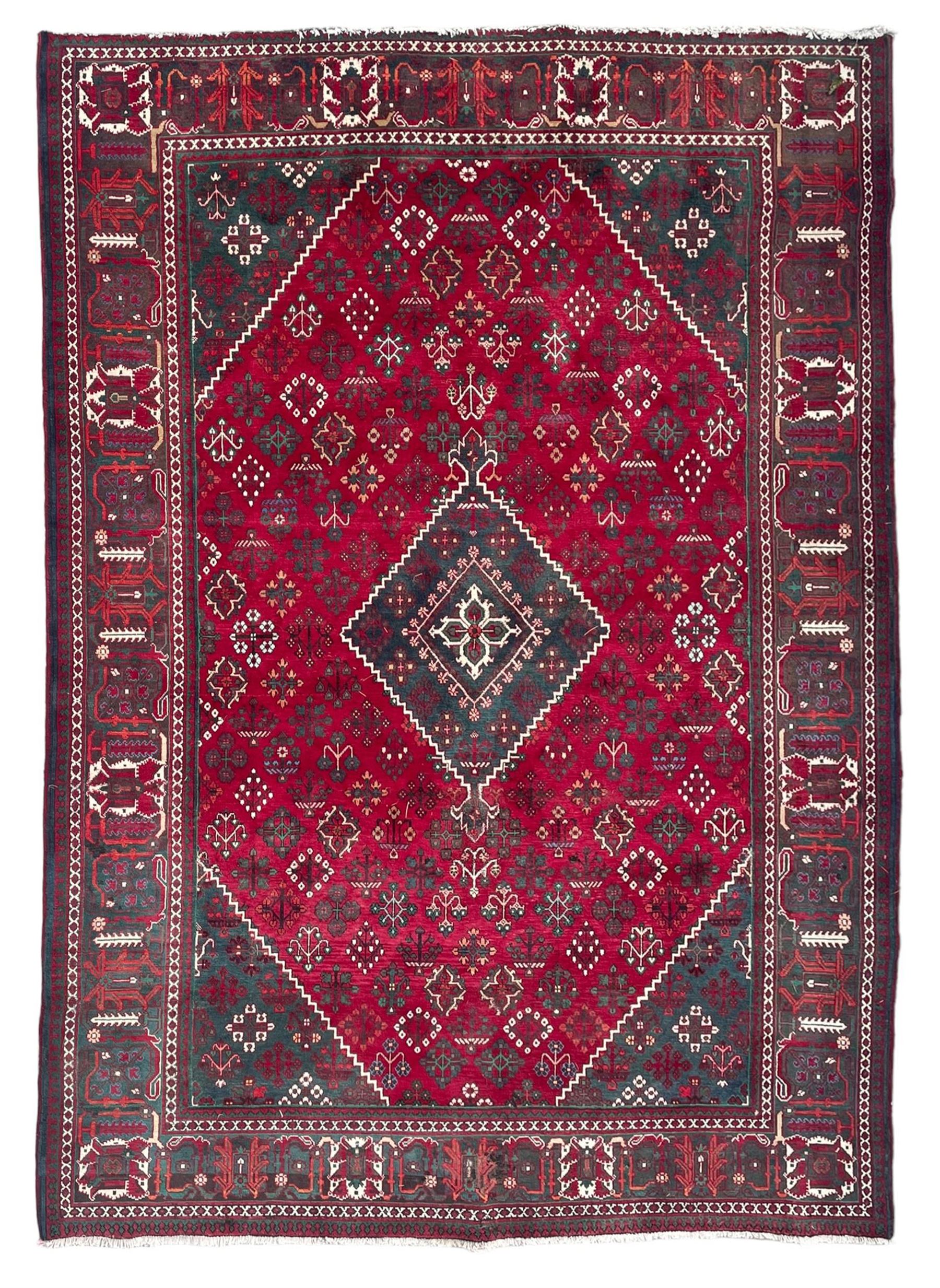 Persian Meymeh red ground rug, stepped lozenge medallion and spandrels, decorated all over with tree of life motifs, the main border decorated with repeating stylised plant motifs within geometric guard stripes 