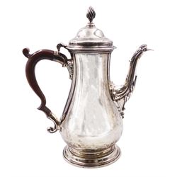 George III silver coffee pot, of baluster form with foliate detail to spout, flambeau finial to the hinged cover and wooden scroll handle, upon a stepped circular foot, hallmarked Francis Crump, London 1766, gross weight 27.85 ozt (866.3 grams)