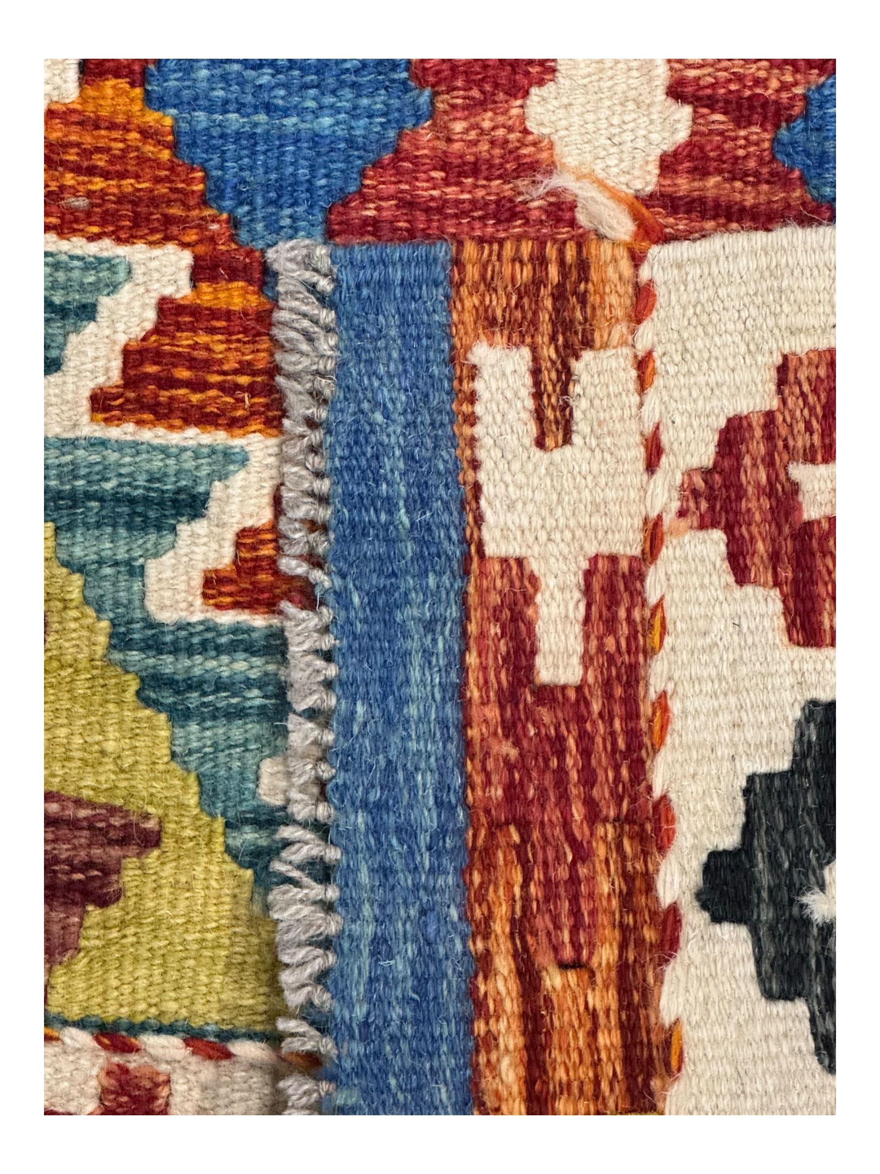 Kilim runner rug, central field decorated with four stacked geometric medallions in a multicoloured zigzag design, bordered by a series of small geometric motifs, fringed edges at both ends