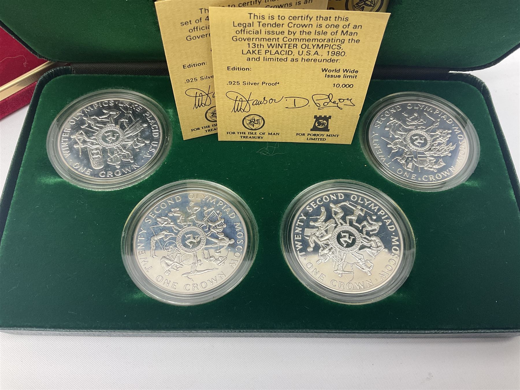 Queen Elizabeth II Isle of Man 1980 'Commemorating the 1980 Olympics' silver proof crown four coin set and 1979 '1000th Anniversary of Tynwald' silver proof crown five coin set, both sets cased with certificates 